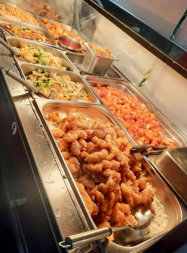 A hot buffet laid out in trays for a club function